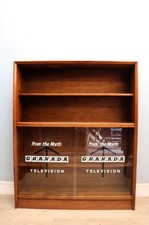 This retro teak bookcase cabinet by Herbert Gibbs, later sign written for Grana