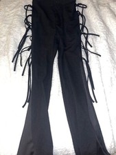 Black slack type pants with fringe, reminiscent of 90s & Y2K style