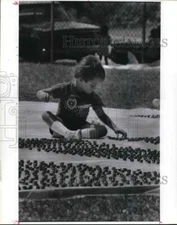 1987 Press Photo Brian Castro Surrounded by Pennies at Hidalgo Park in Houston.