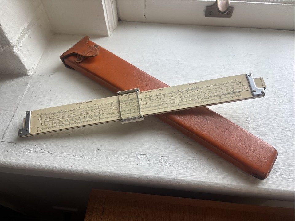 A Keuffel & Esser slide rule with a leather case and a 1908 patent — K&E is the Rolex of slide rules, and this one has the provenance to match.