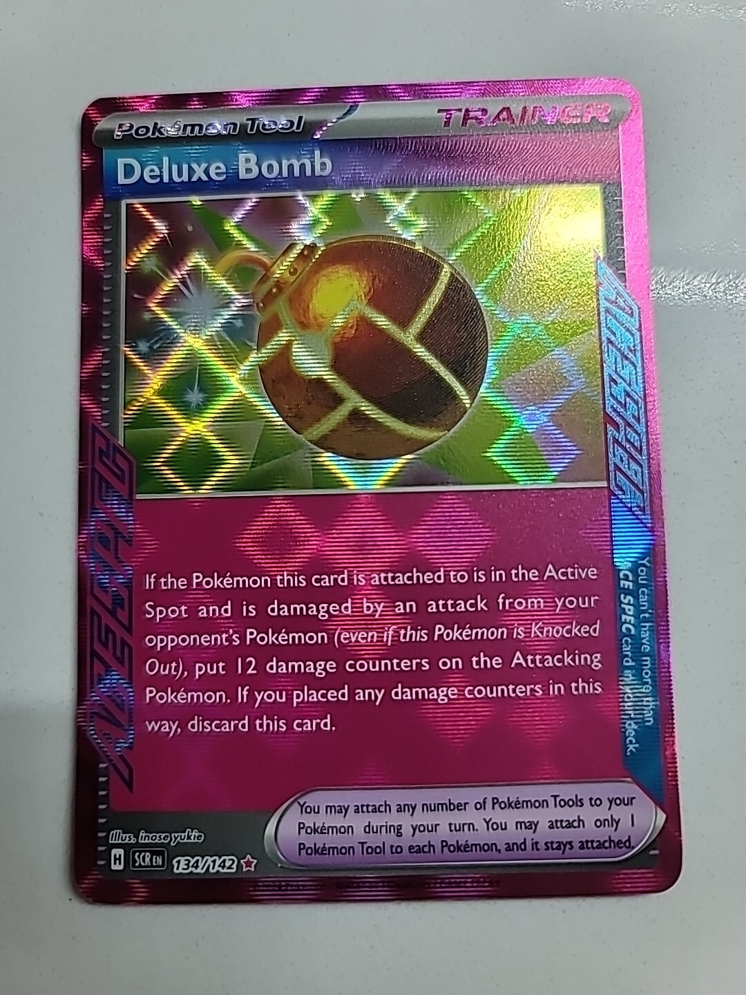 Deluxe Bomb 134/142 -Pokemon TCG S&V Stellar Crown SCR- NM ACE SPEC Trainer HOLO