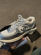 Chanel CC Runner Gold Laminate sneakers.