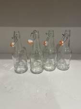 Four Swing Top 16 oz clear glass bottles