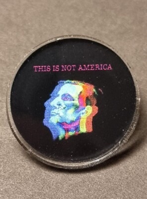 This Is Not America (Claes Bang) 2.5cm acrylic pin badge with rubber clutch.