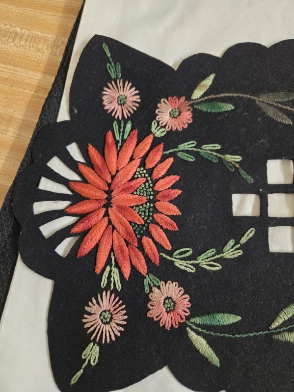Vtg. black felt table runner w/stitched floral designs and cutout areas.