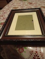 Dark Wooded Picture Frame With A Beaded Around The Glass And It's Ornated Around
