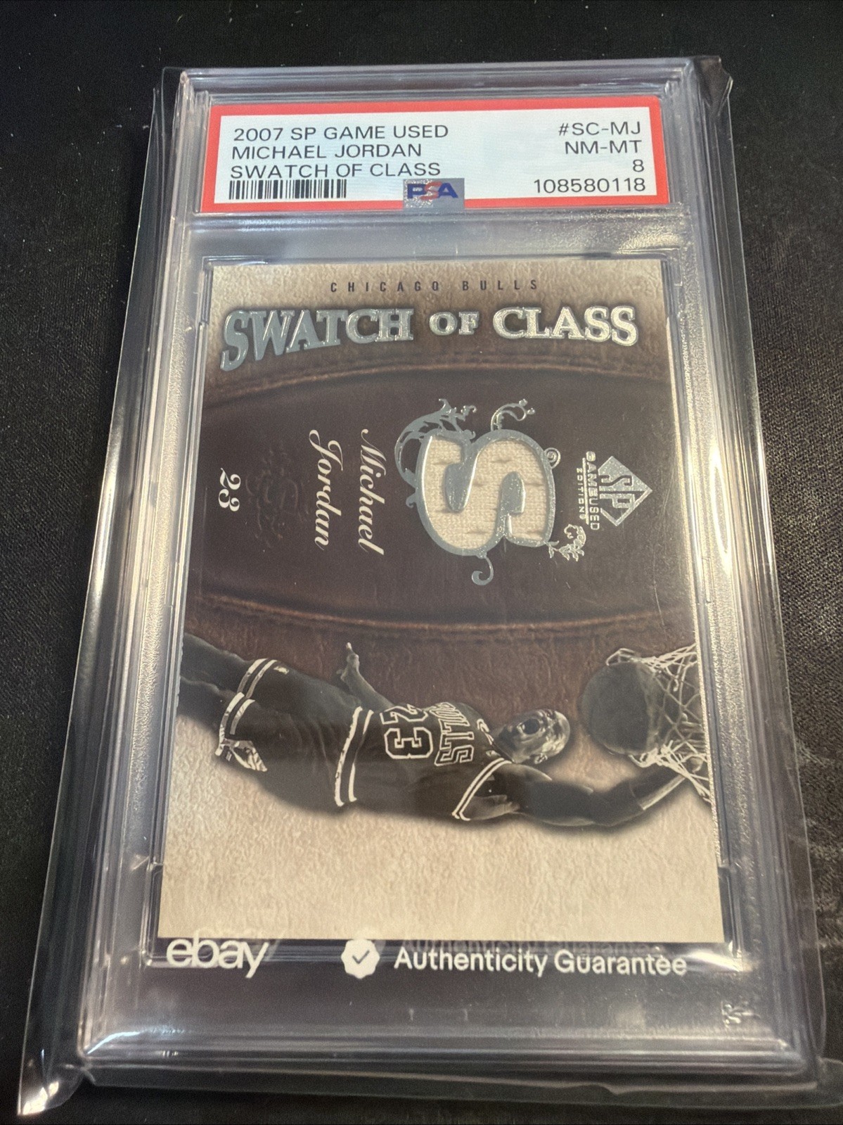 2007-08 SP Game Used Michael Jordan Swatch Of Class Jersey Bulls PSA 8 view 1