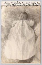 Real Photo Postcard Infant in Long White Gown on Fur Rug c1910 RPPC
