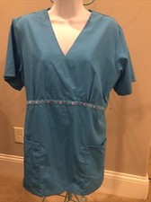 SB Scrubs blue v neck short sleeved pockets, tie waist circle pattern accent top