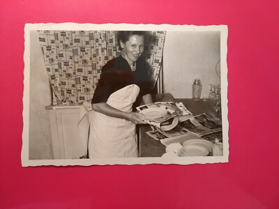 Old photo antique woman woman packing plates in newsprint moving nice old photo