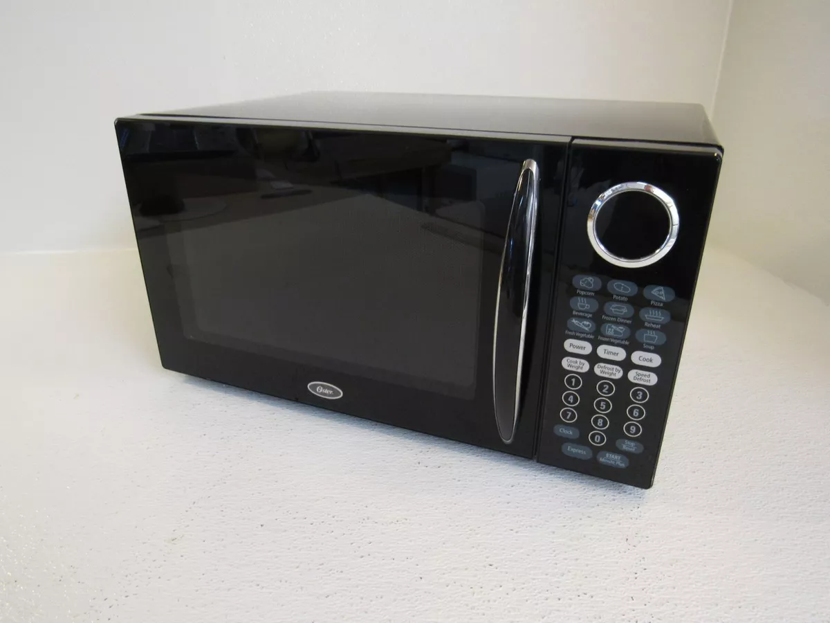 OSTER 1.1 CU. FT. COUNTERTOP MICROWAVE OVEN pre owned