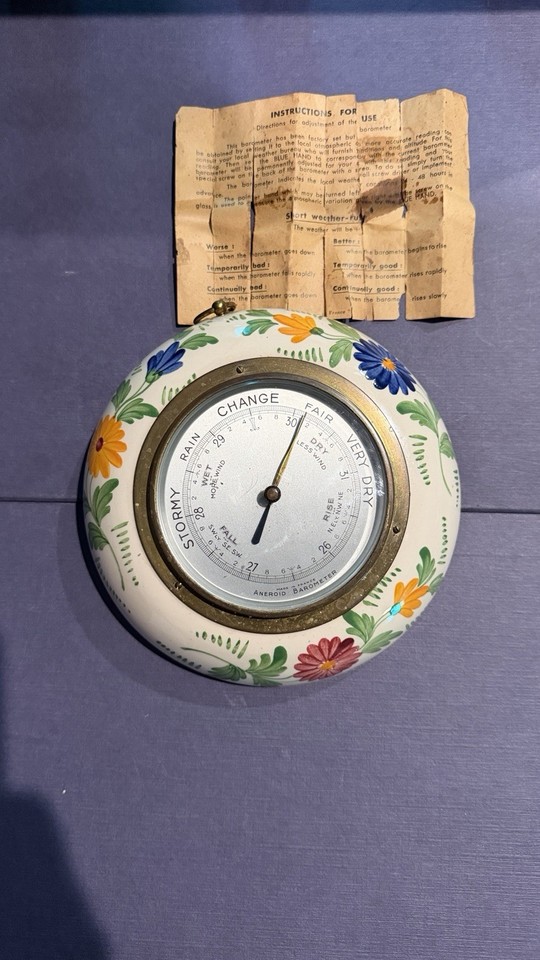 A working 1955 French aneroid barometer dressed in hand-painted ceramic floral art — science meets cottage-core antique, complete with original manual.