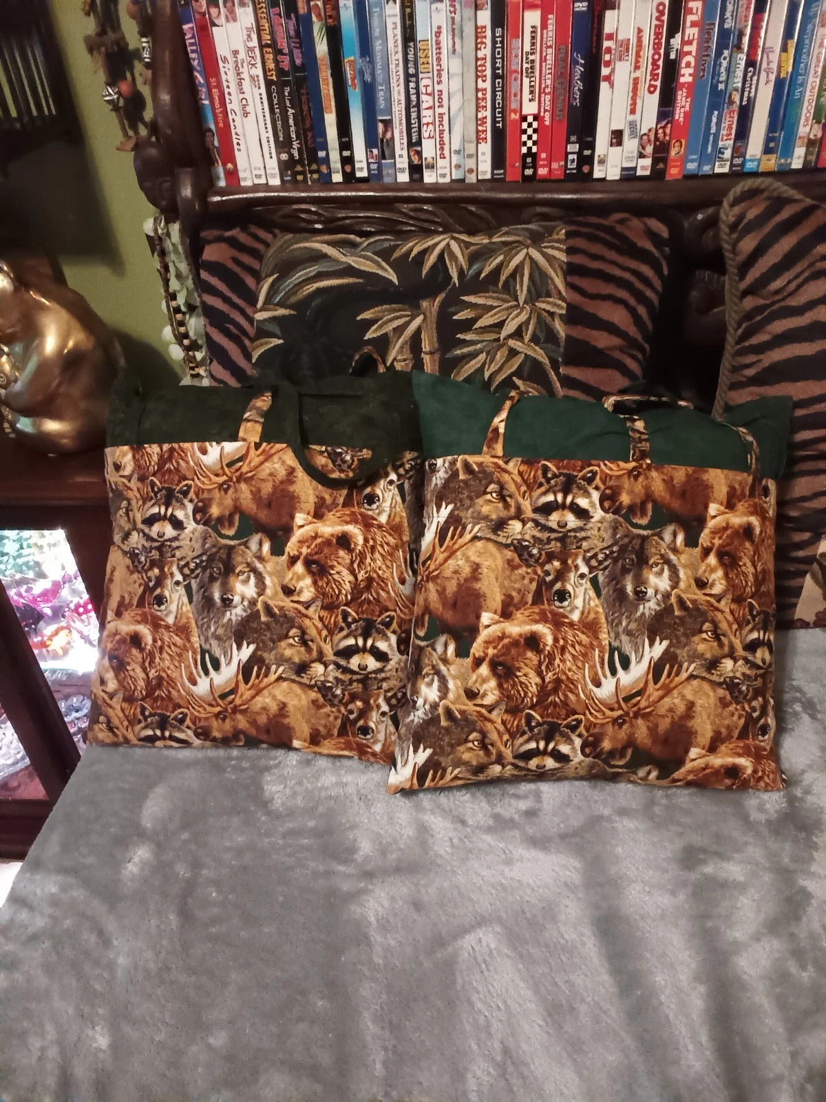 Pair wildlife pillow covers over green pillows.