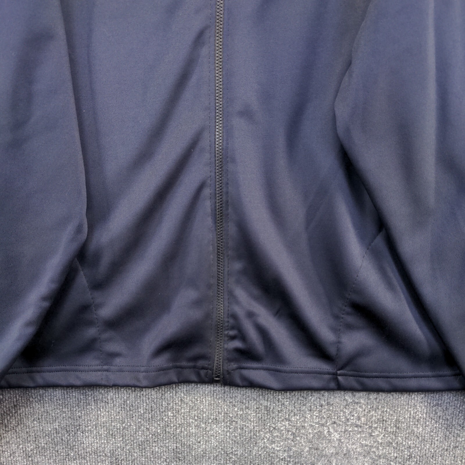 Dark blue men's full zip jacket with front pockets, zipper closure, and "Made in USA" label on back.