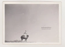 Solitary Rider Against the Sky Minimalist Ode to Freedom and Vast Horizons Photo