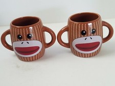 Pair of Brown Ceramic Double-Handled Sock Monkey Coffee Mugs. Made by Galerie.