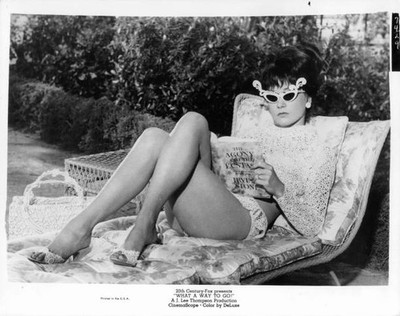 Shirley MacLaine outside reading a book in the film What A Way To - Old Photo