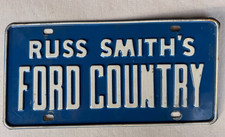 Vintage Russ Smith's Ford Country License Plate Booster STEEL Dealership Nice