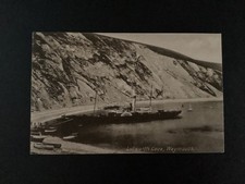 An Edwardian postcard of Lulworth Cove with a paddle steamer - c 1910.