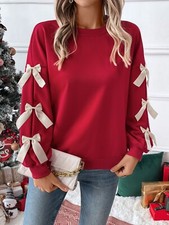 Festive and playful red pullover sweatshirt with round neck and bow