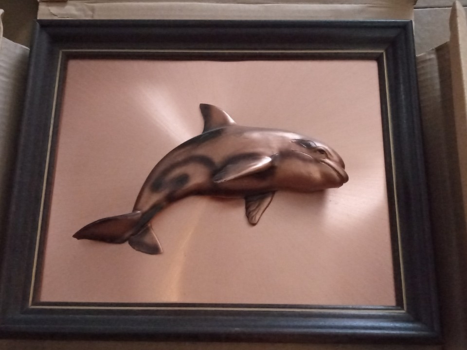 Chunky 3D copper dolphin wall plaque in a hardwood frame — pure 70s/80s coastal kitsch that's genuinely charming as a retro accent piece.