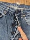 Vintage Levi’s 501XX blue denim with silver rivets, button closure, and “Made in U.S.A.” tag on waistband.