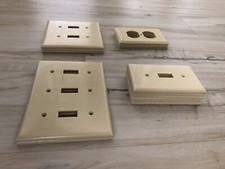Lot of beige wall plates: outlets and single, double, and triple light switches
