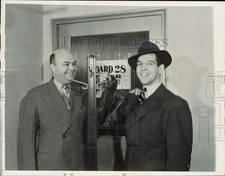 1941 Press Photo Charles Fenske hangs up track shoes at Draft Board 28
