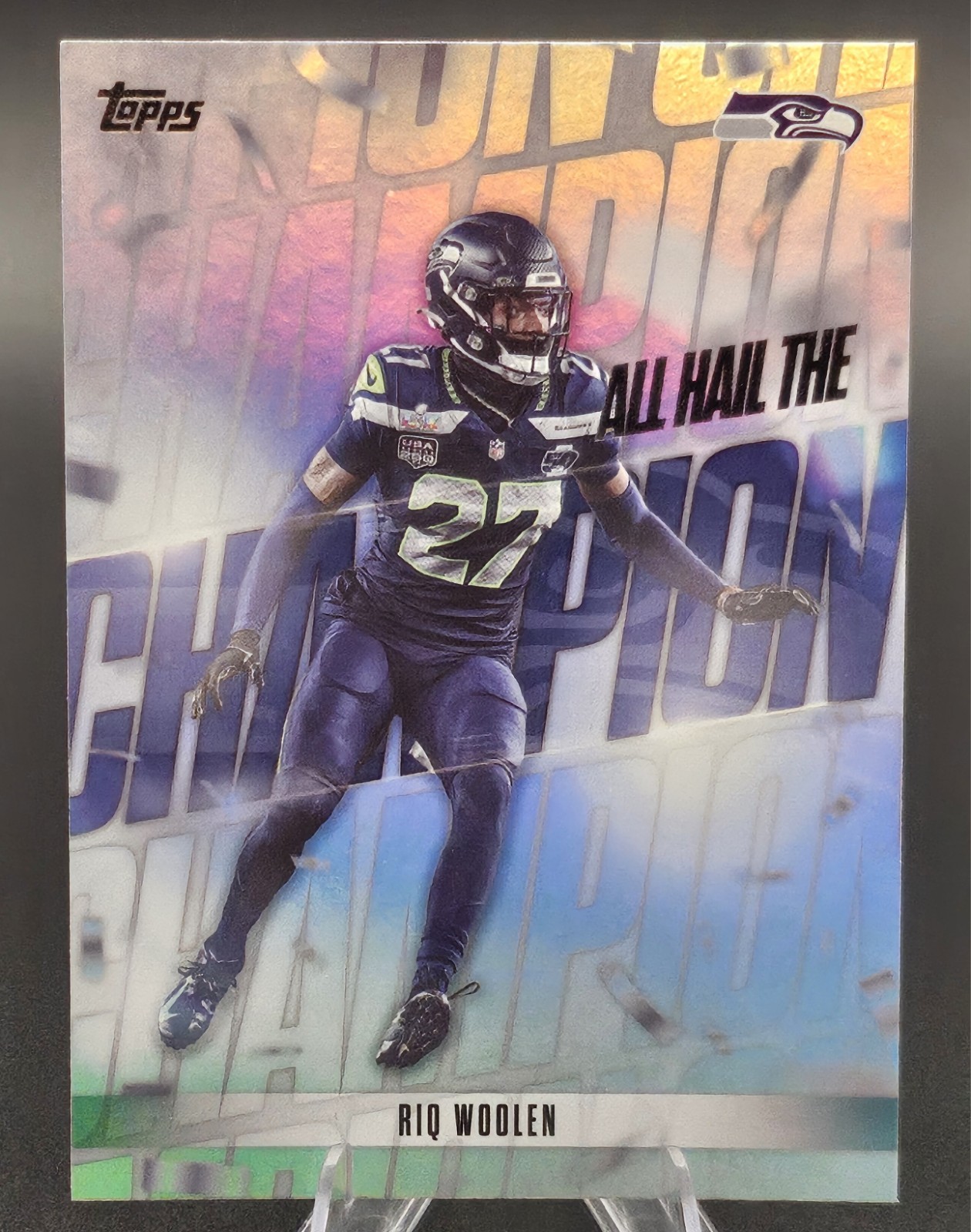 Riq Woolen 2026 Topps Flagship Football All Hail The Champion Sea #AHC-13, SSP