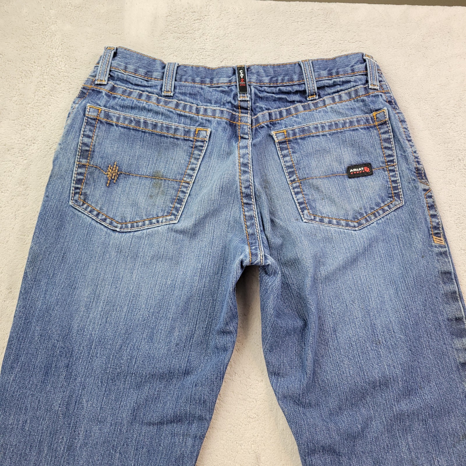 S 34x30 Blue Wash Low Rise Boot Denim Work Pant Stains Hole