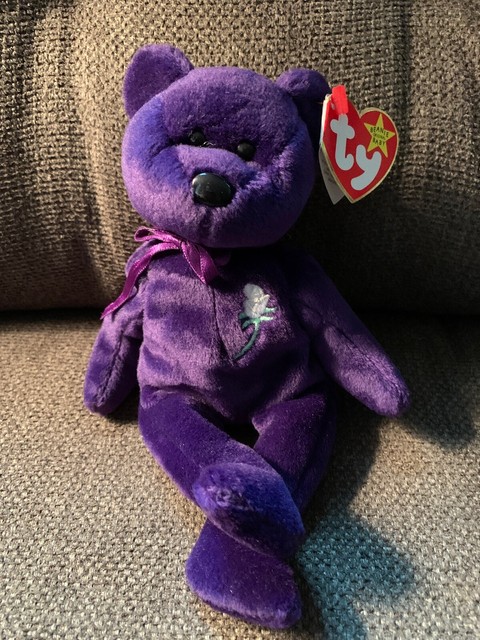 purple beanie baby with white flower