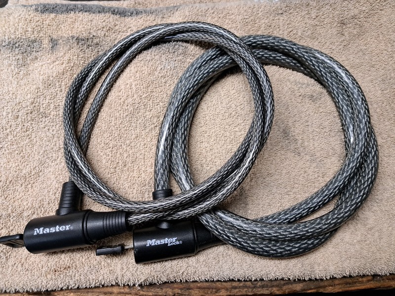 Assortment of Master Locks. Puck and Two Different Thickness Six Foot Cables.