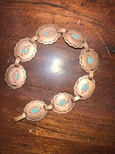 Western-style copper concho belt with turquoise-colored stones.