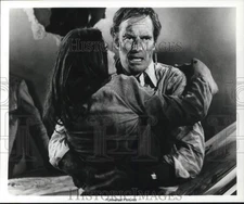 Press Photo Charlton Heston and Genevieve Bujold in a scene from "Earthquake."