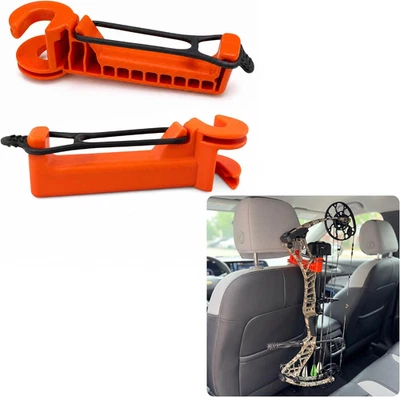 Two orange plastic Bow Buddy bow hanger hooks with black straps and mounting holes, shown on a gray car seat.