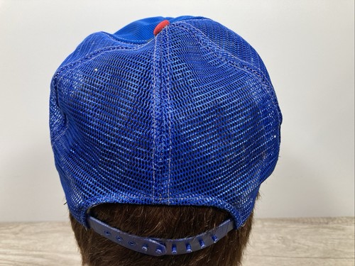 Blue US-made wide-stripe trucker hat with red cap, silver buckle, and mesh fabric on a mannequin head.