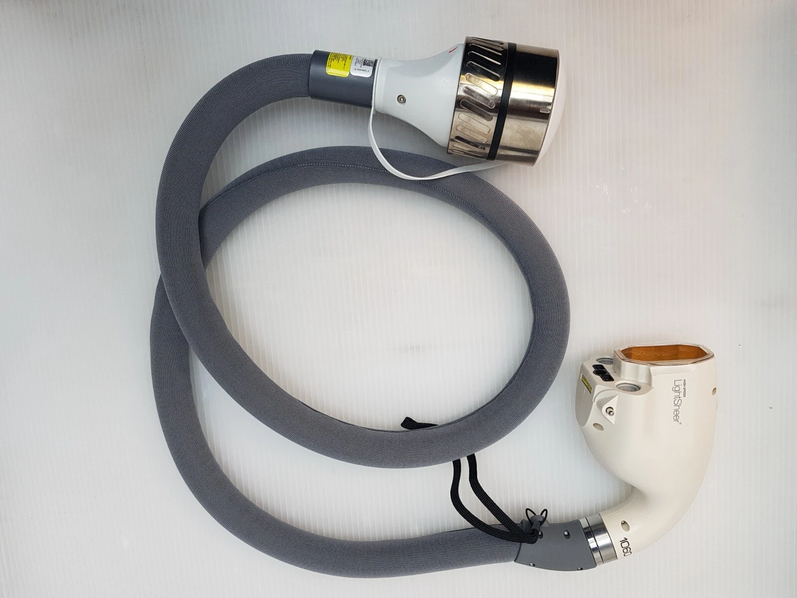 Complete LightSheer High Speed 1060 handpiece assembly with coiled grey cable and metal connector