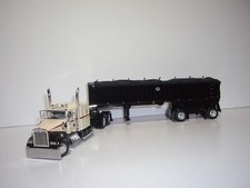 DCP PRIMERA MARCHA 1/64 BEIGE Y NEGRO KW W900L CON DUMMIENTE Y EJE EXTENDIDO MAC CARBÓN DUMP