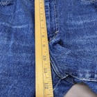 Blue denim high-rise straight-leg Lee jeans with front pockets, yellow measuring tape along the waistband.