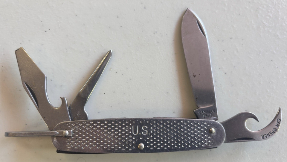 A genuine 1977 US Military-issued Camillus 4-blade multi-tool — actual Cold War-era pocket gear with provenance.