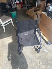 Foldable wheelchair with detachable footrest and straps.