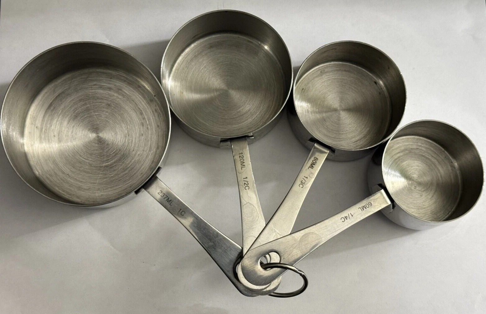 Oneida Stainless Steel 4pc Measuring Cup Set 1 Cup, 1/2 Cup, 1/3 Cup, 1/4 Cup.