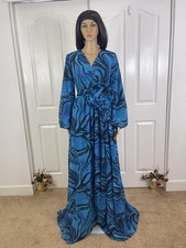 Vibrant Blue Patterned Wrap Maxi Dress with Flower Accent