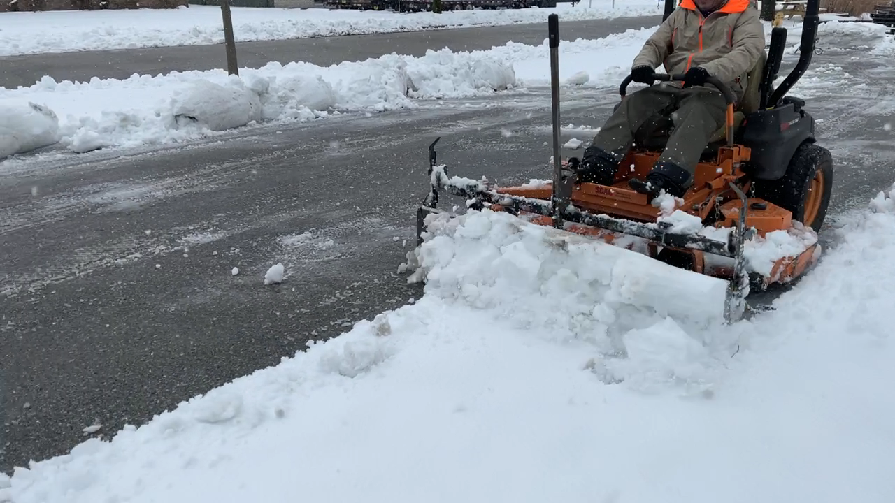 Swinging Tool Bar and Snow Blade Ezra Lawn Care Equipment mounts on a