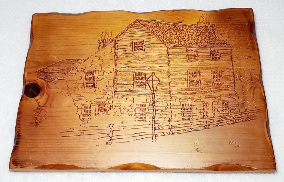 A signed 1984 hand-burned pyrography cabin scene — genuine folk art you won't find twice, with real handmade soul.