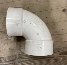 Montaje de codo de 90 grados Charlotte Pipe PVC DWV 8 pulgadas