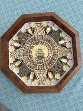 This intricate shell design in a walnut frame resembles a sailor’s valentine.