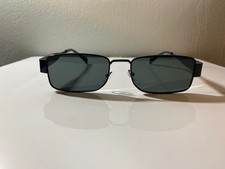 Unisex, black framed sunglasses with rectangular smoke gray lenses.