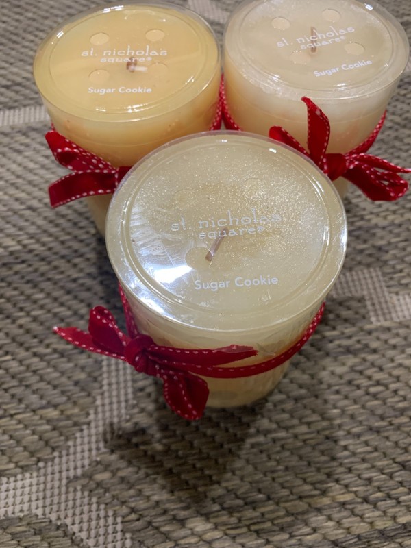 Three St. Nicholas Square branded sugar cookie scented candles