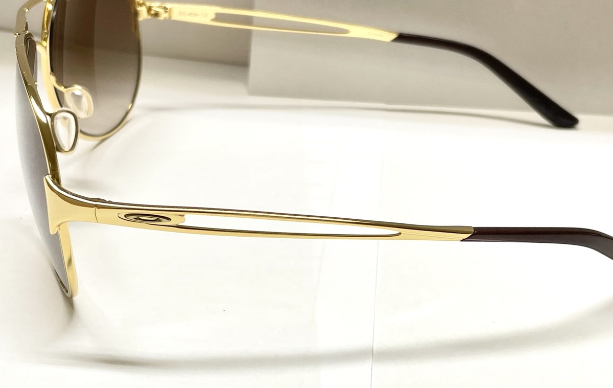 Oakley Sunglasses Caveat Polished Gold Frame Brown Gradient Oakley Sunglasses Caveat Polished Gold Frame Brown Gradient
